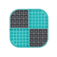 A turquoise square hard case mat with numbs and squares inside.